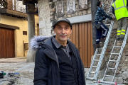 El artista Florencio Maíllo posa mientras colocan nuevos retratos en las fachadas de Mogarraz (Salamanca). / ARGICOMUNICACIÓN