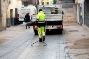 Un operario desinfecta con una manguera la céntrica calle de Santa María de Tordesillas. - EL MUNDO