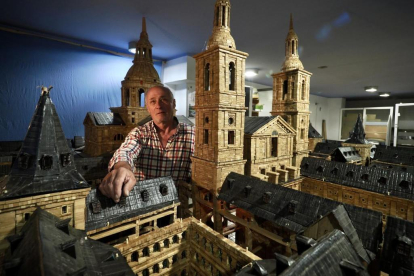 Ángel Rodríguez, en su estudio, posa junto a su maqueta de El Escorial