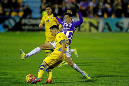 Juan Villar intenta cortar el centro de Bellvís, ayer, en el partido disputado en el estadio Santo Domingo.-LOF