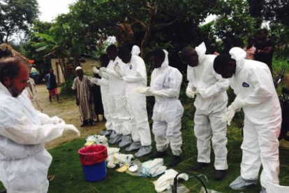 Voluntarios preparándose para ponerse los monos de aislamiento para tratar con enfermos de ébola, en Sierra Leona.-Foto: HANDOUT / REUTERS
