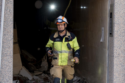 El bombero Juan Carlos Rodríguez, ayudando en la recuperación de enseres personales en el edificio de la calle Goya 32.- PABLO REQUEJO / PHOTOGENIC