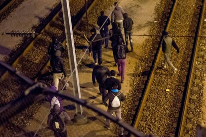 Un grupo de inmigrantes camina por las vías del Eurotunnel, este martes.-Foto: AFP / PHILIPPE HUGUEN