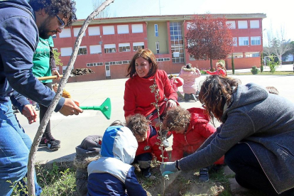La concejala de Medioa Ambiente, María Sánchez, ayuda a plantar un árbol junto a varios alumnos.-E. M.