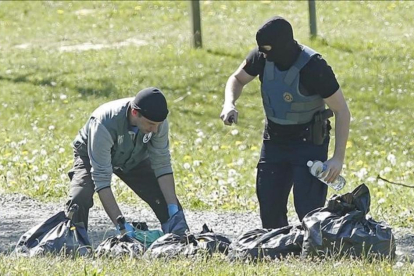 Agentes de la policía francesa inspeccionan uno de los zulos entregados por ETA, en la localidad de Saint-Pée-sur-Nivelle.-EFE / GUILLAUME HORCAJUELO