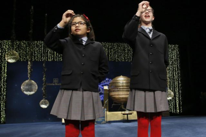 Las niñas de San Ildefonso Lorena Stefan y Nicol Valenzuela muestran las bolas del número 79140, el Gordo de Navidad.-EFE / SERGIO BARRENECHEA