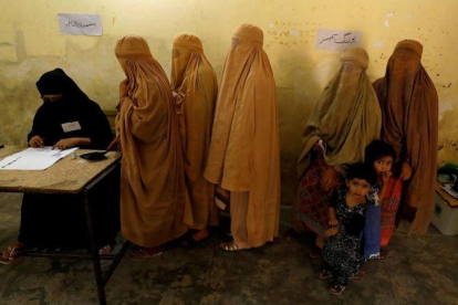 Mujeres ataviadas con burkas votan en un colegio electoral en Peshawar.-FAYAZ AZIZ / EFE
