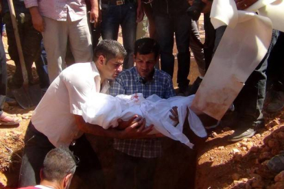 Abdulá Kurdi entierra el cuerpo de su hijo de tres años, Aylan, en su ciudad natal, Kobane.-AFP/ANHA