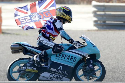 Danny Kent pasea la bandera británica por el circuito de Cheste tras convertirse en campeón de Moto3.-AFP / JOSÉ JORDÁN