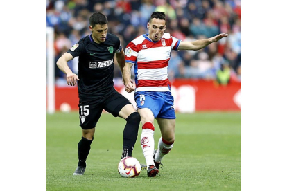Fede San Emeterio (d) pugna por el balón en el partido Granada-Málaga de esta pasada temporada.-LALIGA