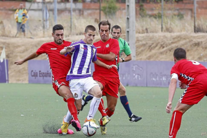 Toni, el mejor del Real Valladolid B, se zafa de la marca de dos rivales de la Cultural Leonesa.-Miguel Ángel Santos