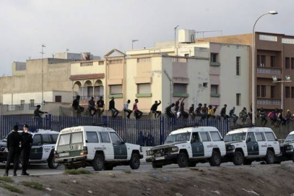 Inmigrantes en la valla fronteriza de Melilla.-Foto: FRANCISCO G. GUERRERO