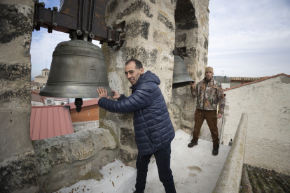 Jesús Serrano, en primer plano, y Fernando del Río, hacen sonar las campanas de la iglesia de San Esteban de la localidad deSan Miguel delArroyo. PEDRO ARRANZ