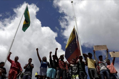 Un grupo de gente protesta en la frontera entre Brasil y Venezuela.-REUTERS / RICARDO MORAES