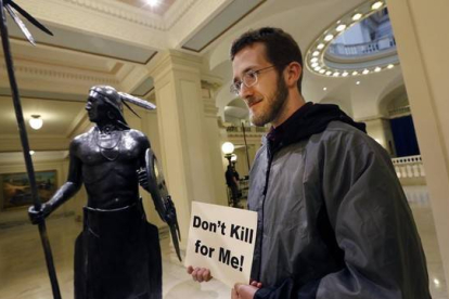 Sam Jennings, de la Coalición de Oklahoma contra la pena de muerte, sostiene un cartel en contra de la pena capital en el Parlamento estatal de Oklahoma, el 29 de abril.-Foto:  AP / STEVE GOOCH
