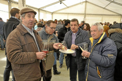 Un grupo de personas degustan queso y vino en una foto de archivo de la Fiesta del Vino Nuevo de Mucientes .-S.G.C.