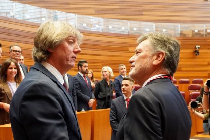 El nuevo presidente de las Cortes, Francisco Vázquez, recibe las felicitaciones del portavoz del Grupo Socialista, Carlos Martínez Mínguez.