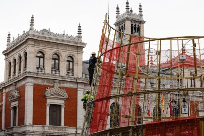 Operarios instalan la base del árbol de Navidad en la Plaza Mayor. -J.M. LOSTAU