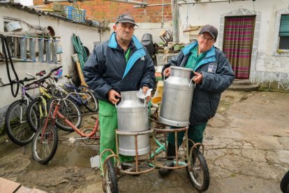 Gregorio Serrano con su hermana María de Las Mercedes descargan las cántaras de leche a la espera de que vengan a recogerlas