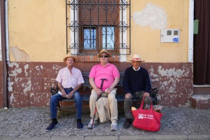Virgilio, José Luis y Pedro descansan en un banco de la calle del Barco.