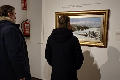 Dos hombres contemplan 'Que en Rusia están'.