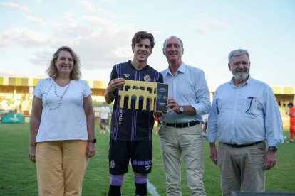 El capitán Alejo muestra el trofeo de ganador, junto a las autoridades.