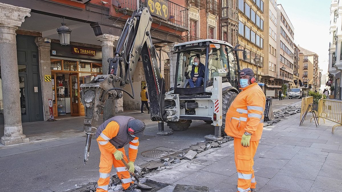 Dos operarios en unas obras de pavimentación. | J.M. LOSTAU
