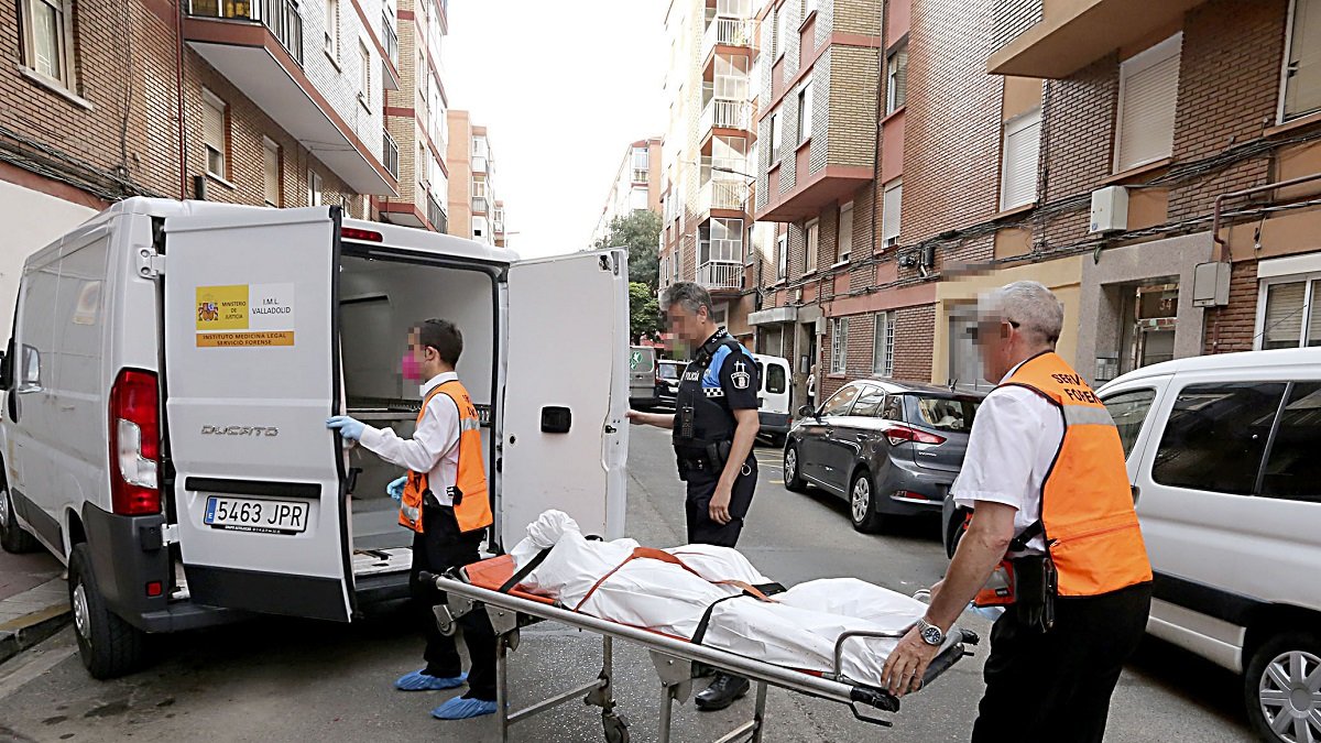 Los servicios funerarios retiran los cadáveres de dos mujeres de una vivienda de la calle Linares 32, en el barrio de la Rondilla de Valladolid.- Ical