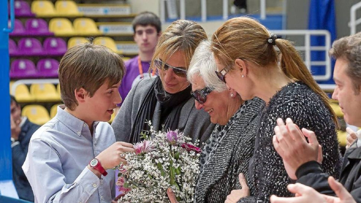 El hijo mayor de Lalo, su madre y sus hermanas, con el ramo de flores que les entregó la plantilla-Pablo Requejo
