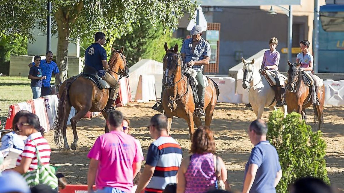 Un grupo de visitantes observa el entrenamiento a caballo de participantes de la Feria, en el Parque de la Dársena del Canal.-MIGUEL ÁNGEL SANTOS