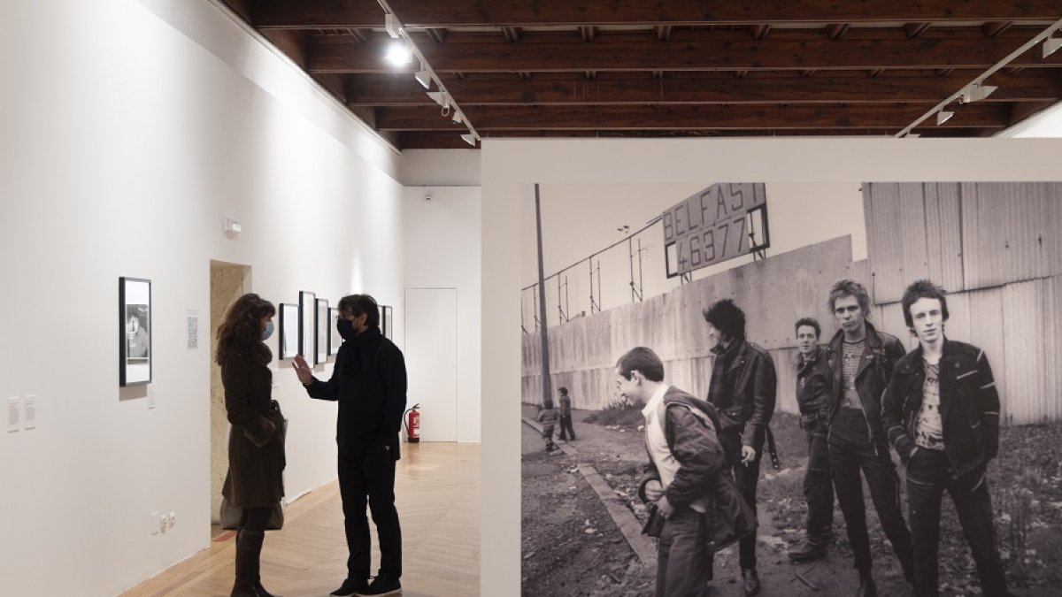 Redondo y Martín Pareja conversan junto a una gran imagen de los Clash en Belfast, de Adrian Boot.  JOSÉ C. CASTILLO