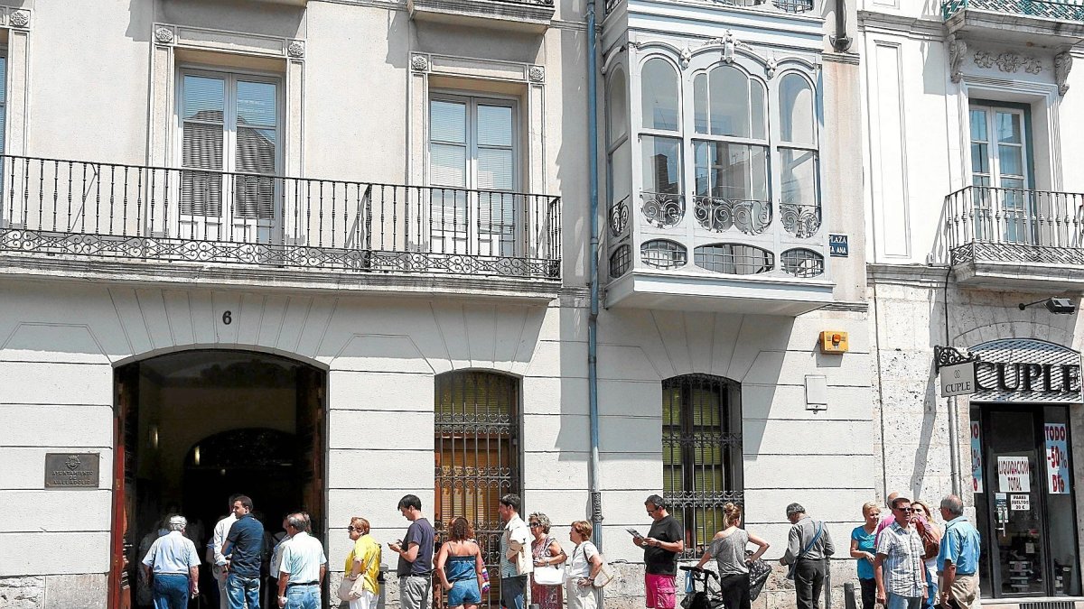 Un grupo de personas hace cola en la oficina tributaria de la plaza de Santa Ana.