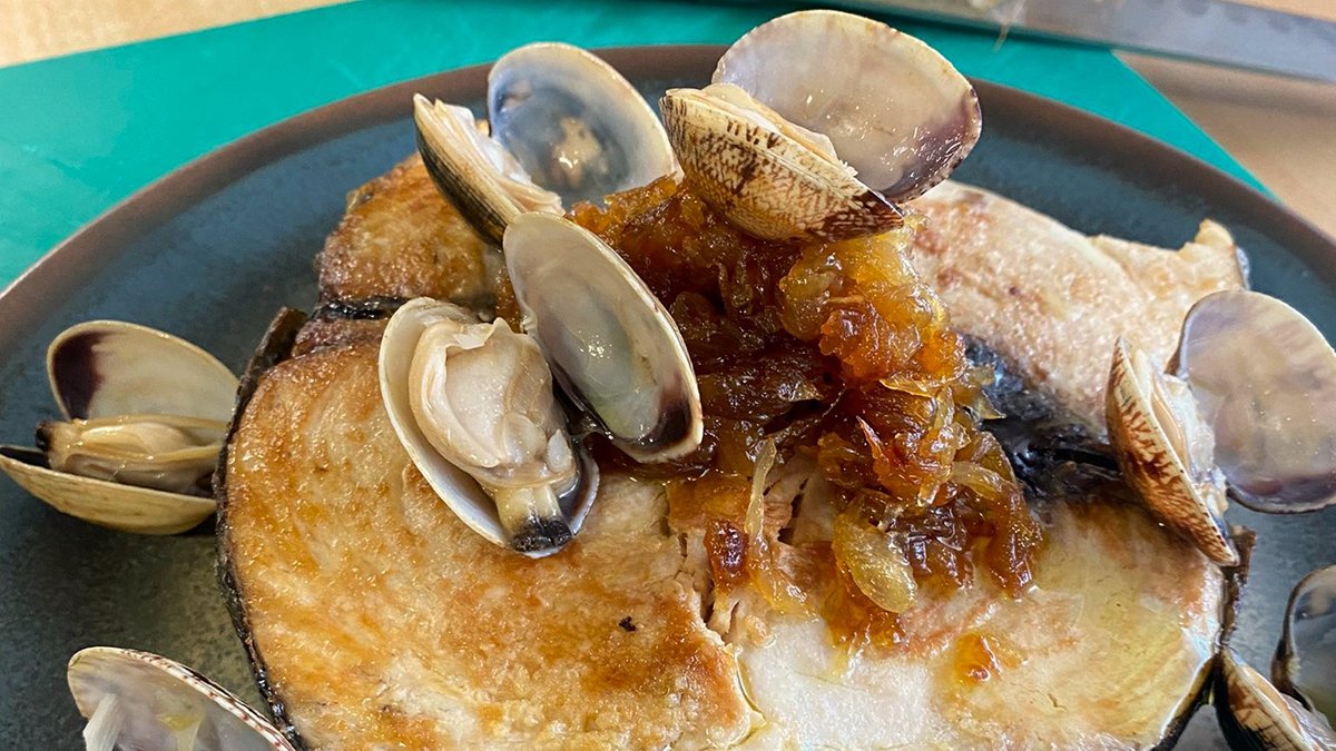 Bonito del norte encebollado con almejas y su jugo.