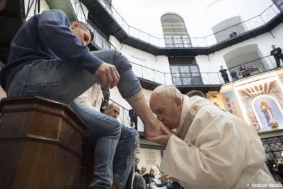 El Papa durante el ritual de lavar los pies a uno de los presos de la cárcel Regina Coeli de Roma.-EL PERIÓDICO (AFP)