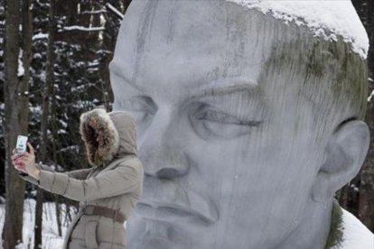 Una mujer se hace un selfi ante una estatua de Lenin cerca de San Petersburgo.-AP / DMITRI LOVETSKY