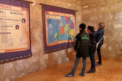 Dos niños y una mujer observan el mapa de Europa en el siglo XVI. En verde, los territorios gobernados directamente por Carlos I y V de Alemania.-M. T.