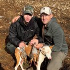Dos cazadores, padre e hijo, con su cupo de una perdiz en un coto salmantino.