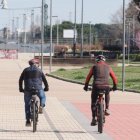 Dos hombres recorriendo la ciudad en bicicleta y disfrutando del buen tiempo
