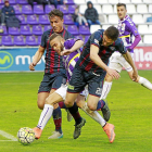 Roger puja por el control de un balón ante el acoso de Camacho y Óscar Ramírez.-J. M. LOSTAU