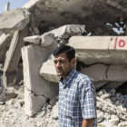 Abdullah Kurdi, el padre de Aylan Kurdi, ante las casas derruidas de sus vecinos, en Kobani.-YASIN AKGUL / AFP
