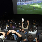 Aficionados siguiendo un partido de fútbol televisado en un cine madrileño.-AGUSTÍN CATALÁN