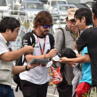 Fernando Alonso firma autógrafos en el circuito de Suzuka, este sábado.-AFP / KAZUHIRO NOGI