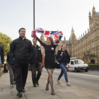 Partidarios de abandonar la UE celebran el resultado del referéndum mientras pasan frente al Parlamento, en Londres.-AP / ANTHONY DEVLIN
