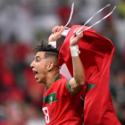 Morocco's defender #18 Jawad El Yamiq celebrates winning the Qatar 2022 World Cup quarter-final football match between Morocco and Portugal at the Al-Thumama Stadium in Doha on December 10, 2022. (Photo by Kirill KUDRYAVTSEV / AFP)