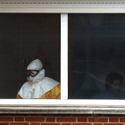Un sanitario, en una de las habitaciones en las que están aislados los pacientes, en la sexta planta del Hospital Carlos III, el jueves.-Foto: AP