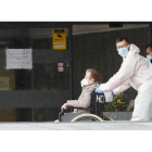 Una mujer es trasladada en silla de ruedas al Hospital Clínico de Valladolid en la mañana de ayer. J.M. LOSTAU