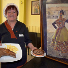 Paulina Ferrero, con el chuletón y las célebres mollejas, junto a un cuadro que muestra el bordado carbajalino, que es la artesanía típica de su pueblo-ARGICOMUNICACIÓN
