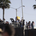 Migrantes en Tijuana, México, miran desde el otro lado del muro durante una visita de la Secretaria de Seguridad, Kirjsten Nielsen.-GREGORY BULL (AP)