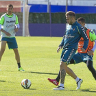 Roger da un pase durante el entrenamiento de ayer, ante la presión de Peña y la mirada de Samuel-P. REQUEJO