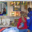 Una pareja observa los artículos de uno de los puestos en la Feria de Artesanía.-P. REQUEJO